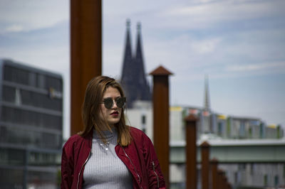 Beautiful young woman against sky