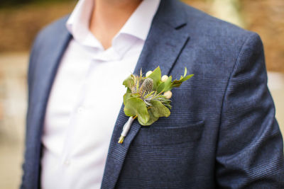 Midsection of woman holding flower