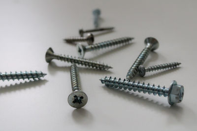 Close-up of screws on white background