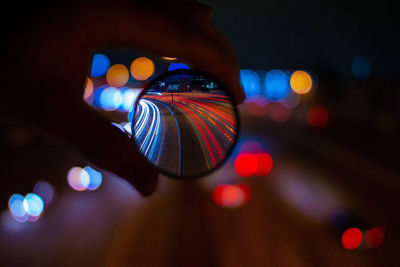 Some light trails in denver on a footbridge