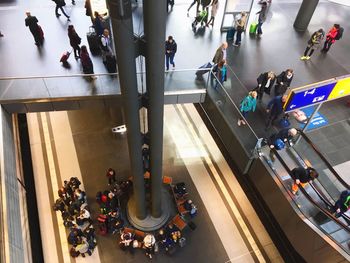 High angle view of people on escalator in shopping mall