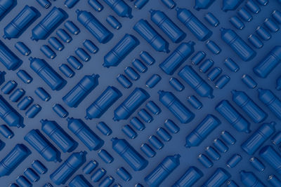 Background of plastic bottles and blue cans on blue background