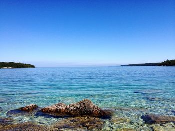 Scenic view of sea against clear blue sky