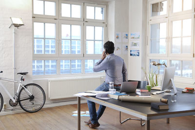 Man using cell phone in a modern informal office