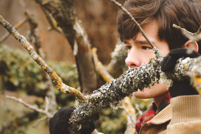 Close-up of thoughtful man by tree