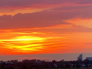 Silhouette buildings against sky during sunset