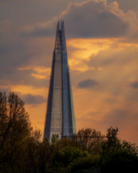 Low angle view of tower against cloudy sky