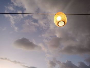 Low angle view of illuminated lamp against sky