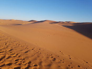 Scenic view of desert against clear sky