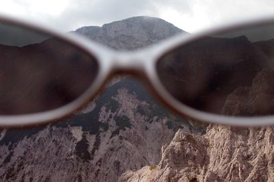 Close-up of sunglasses on rock