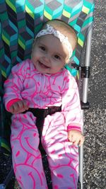 Portrait of cute baby girl in stroller