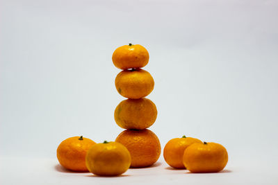 Close-up of fruits on apple against white background