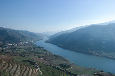 High angle view of river and mountains against clear sky