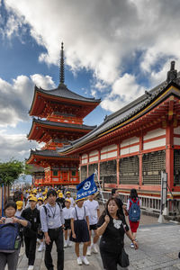 People at temple against sky