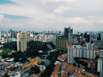 High angle view of modern buildings in city against sky