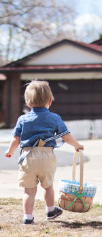 Rear view of boy with arms outstretched