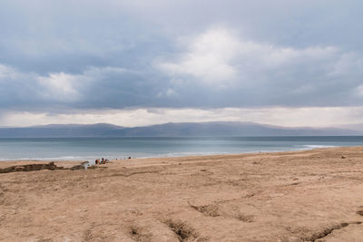 Storm and rain at dead sea coastline. salt crystals at sunset. texture of dead sea. salty seashore