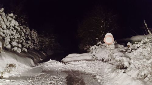 Man in snow at night
