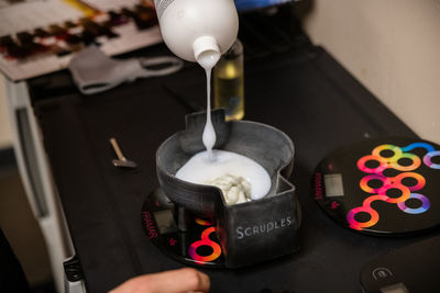 High angle view of hand pouring wine in glass