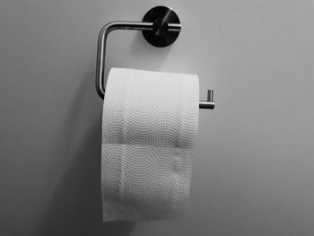 Close-up of toilet paper hanging in bathroom