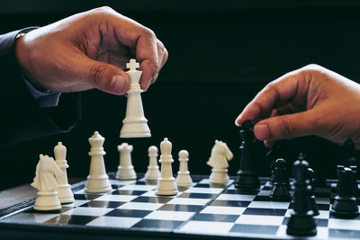 Close-up of hands playing chess