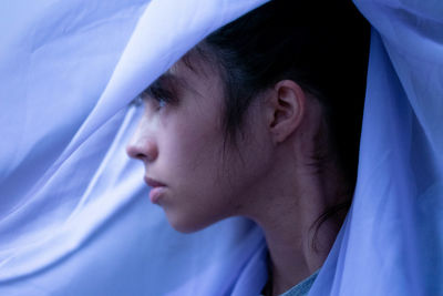 Close-up of woman wrapped in purple fabric