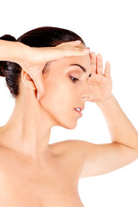 Close-up portrait of young woman over white background