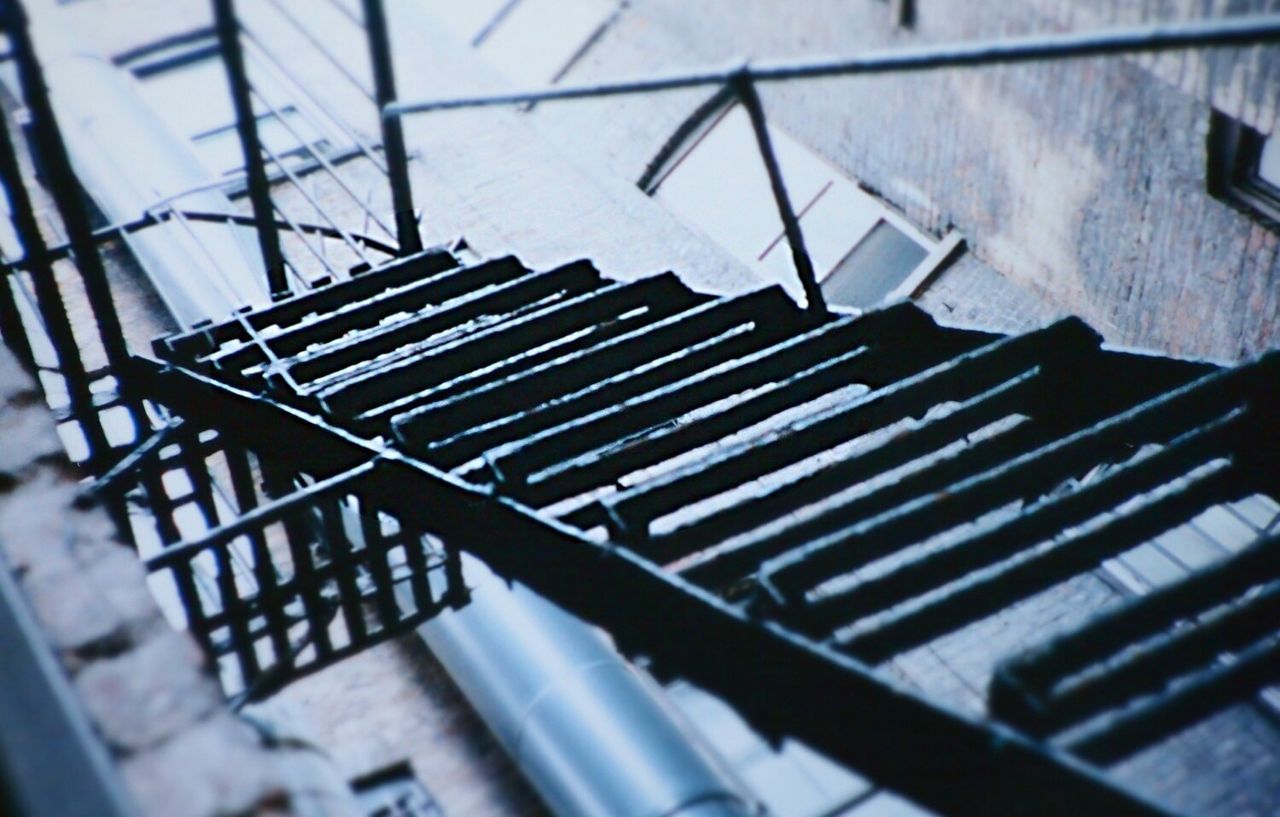 indoors, railing, chair, in a row, empty, wood - material, metal, close-up, selective focus, pattern, steps, absence, seat, repetition, focus on foreground, steps and staircases, no people, day, high angle view, shadow