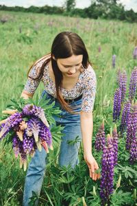 Young woman picking flowers