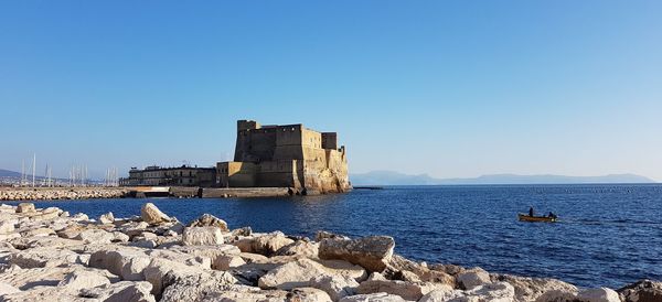 Scenic view of sea against clear blue sky