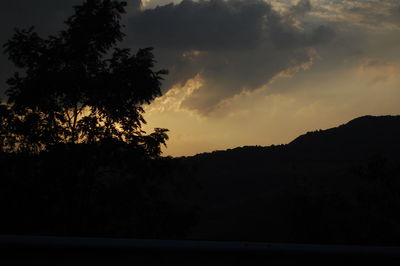 Silhouette trees against sky during sunset