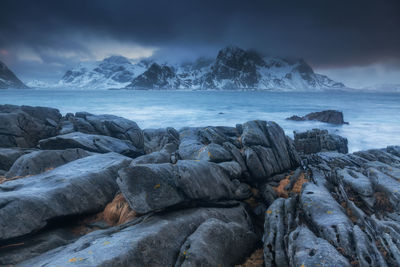 Rocks in sea against sky