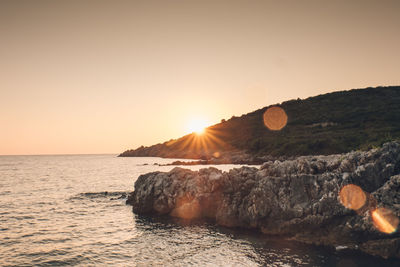 Scenic view of sea against clear sky during sunset