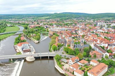 High angle view of townscape and river against sky