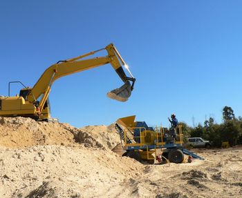 Man working on construction site against clear sky