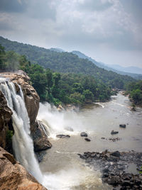 Scenic view of waterfall against sky