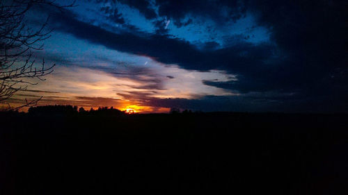 Scenic view of silhouette landscape against dramatic sky
