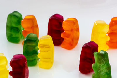 Close-up of multi colored candies against white background