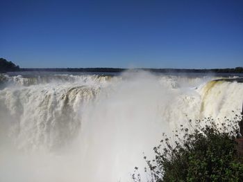 Scenic view of waterfall against clear sky