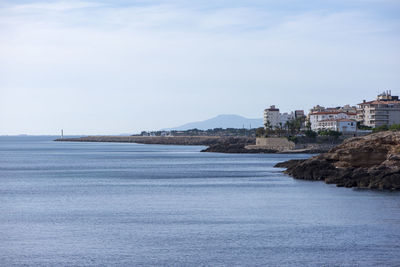 Scenic view of sea against sky in city