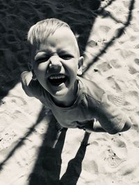 High angle portrait of happy boy on floor