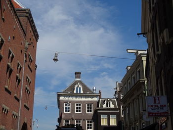 Low angle view of buildings in town against sky