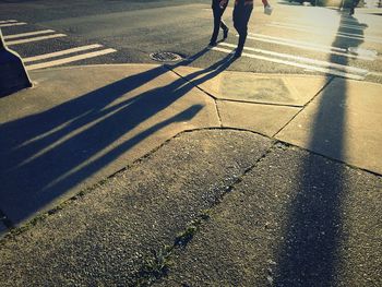 Shadow of people walking on city street