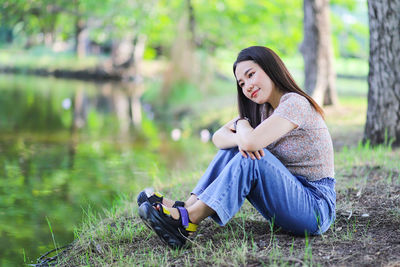 Young woman sitting on land