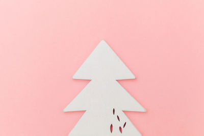 Directly above shot of christmas decoration against pink background