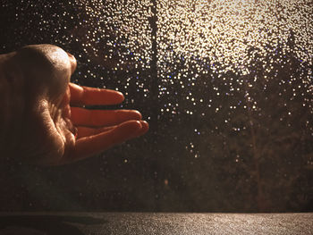 Close-up of person hand on wet floor