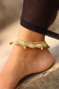 Close-up of woman wearing anklet