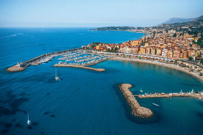 High angle view of sea and buildings against sky