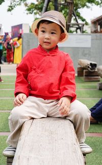 Smiling boy sitting outdoors