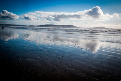 Scenic view of frozen sea against blue sky